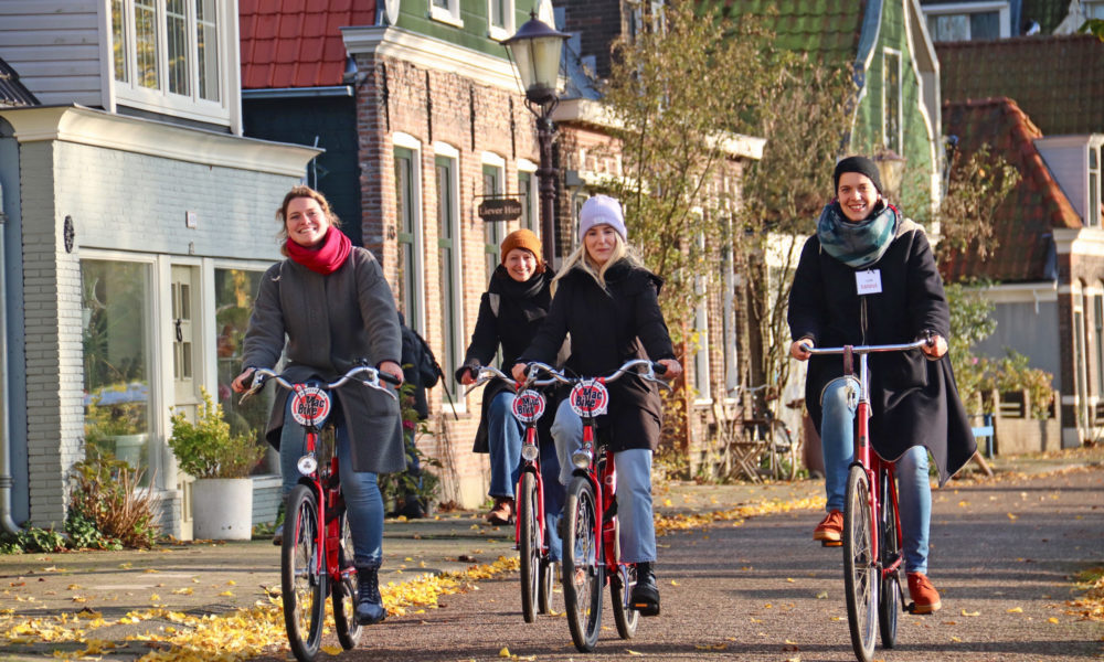 Group of friends cycling through Amsterdam