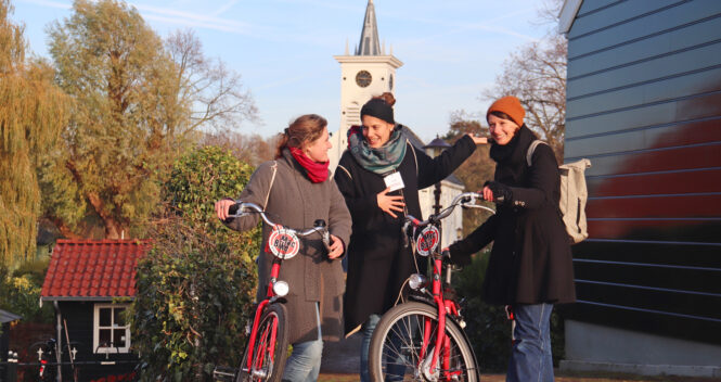 Three friends on a bike tour. Exploring Amsterdam together.