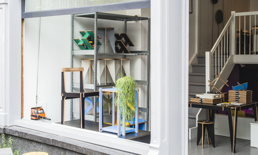 Interior of a home in Amsterdam with furniture and decor. A staircase leads upstairs.