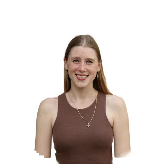 Portrait of a young woman smiling. She is on a city trip to Amsterdam.